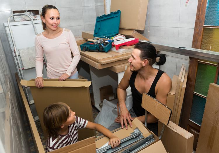 A young family pack their things as they prepare to move