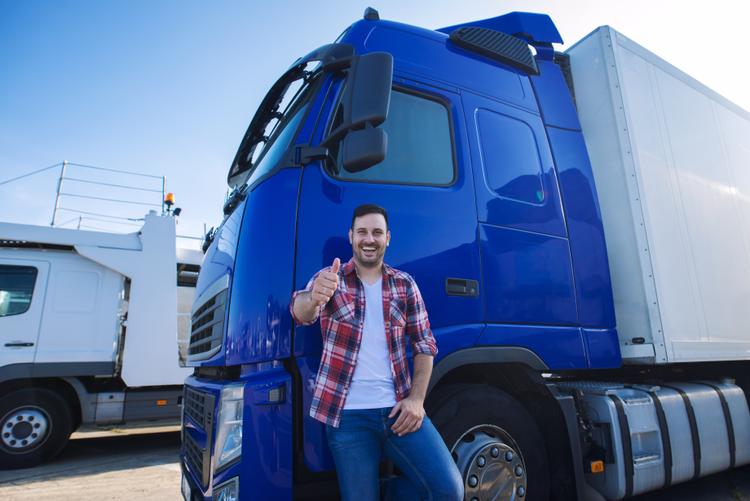 A man standing in front of a removalist truck giving a thumbs up