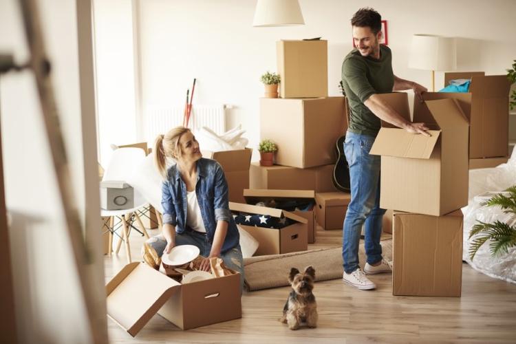 A man and woman packing things into boxes for their removal